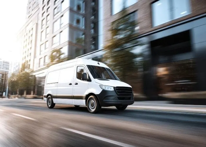 Van speeding down road in city
