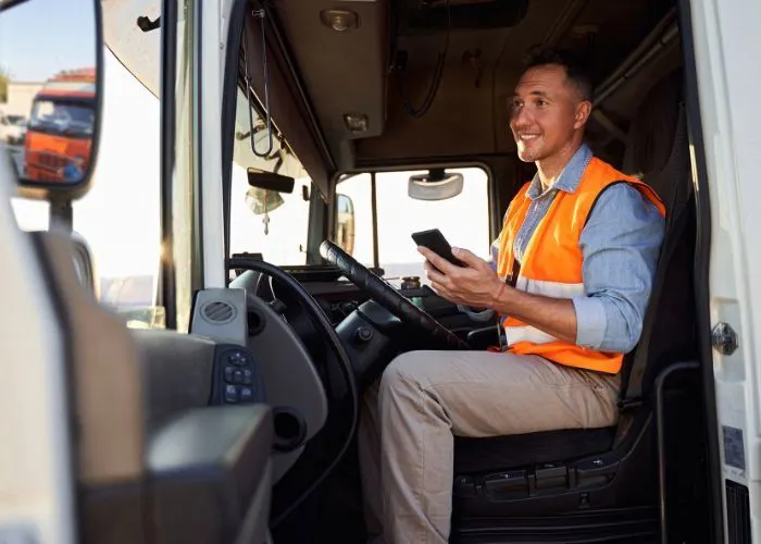 Driver in their vehicle with a phone in hand