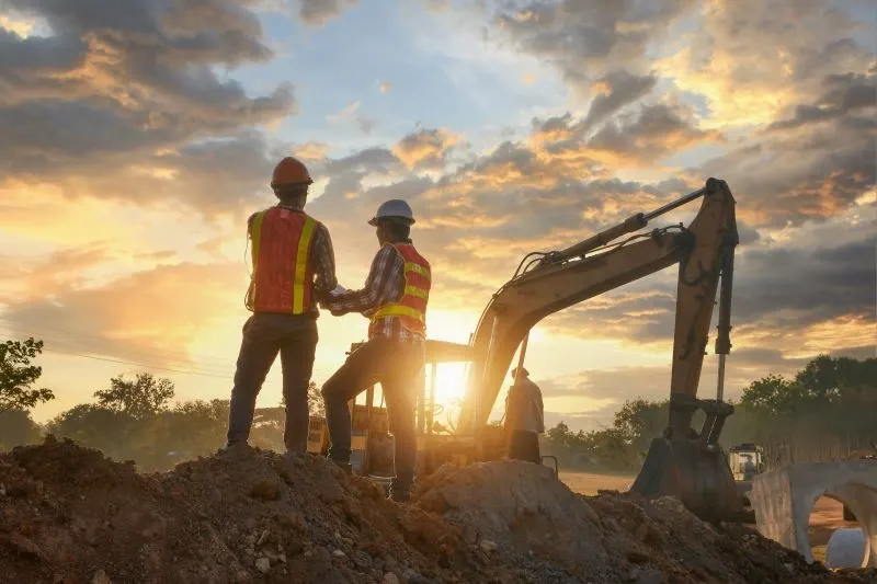 Image of two workers on a construction site using GPS tracking