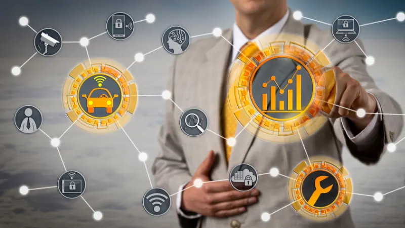 Man in a suit looking at interconnected Vehicle telematics stats such as maintenance and the current location of the vehicle