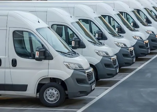 Row of white vans lined up