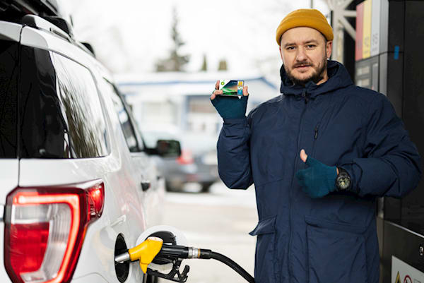 a worker fulling up his vehicle with discounted fuel using his bp fuel card