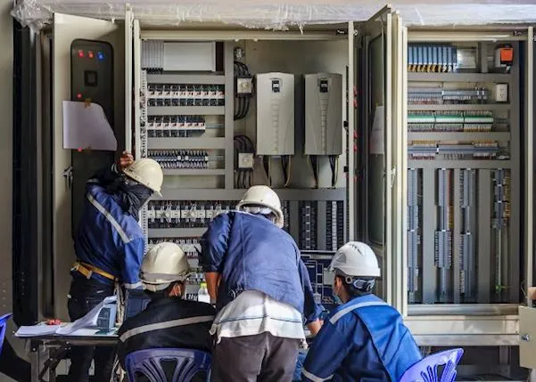 A team of engineers checking the maintenance of an office machine
