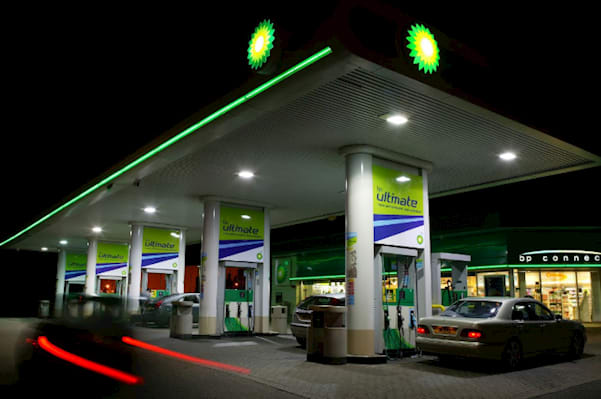 bp fuel station illuminated at night with vehicles at the pumps