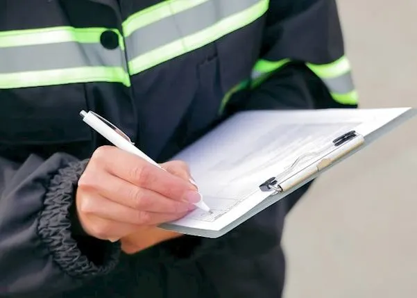 Fleet manager writing on a clipboard