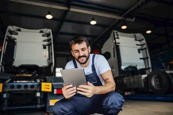 Image of a driver carrying out fleet maintenance vehicle checks.