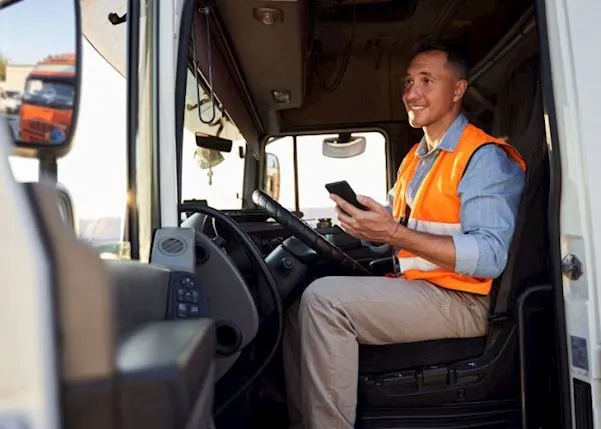 Driver in a vehicle with a phone in his hand