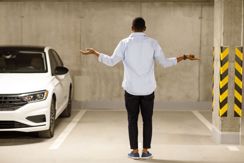 Man looking for his car next to an empty space