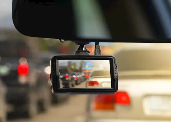 Vehicle driving on a road with a dash cam