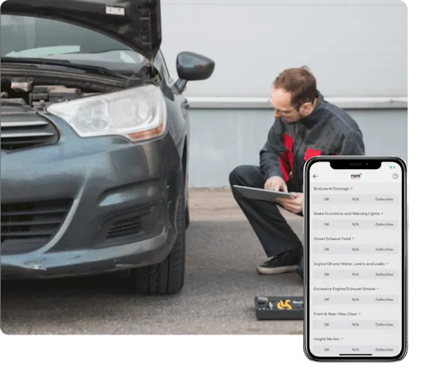 Man carrying out a vehicle check on a grey car that has the hood up. The vehicle check app is in the bottom right corner.
