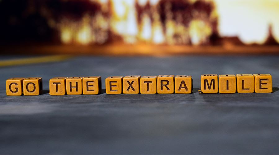 Blocks spelling out 'go the extra mile'