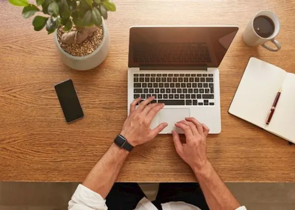 person using a laptop on a desk