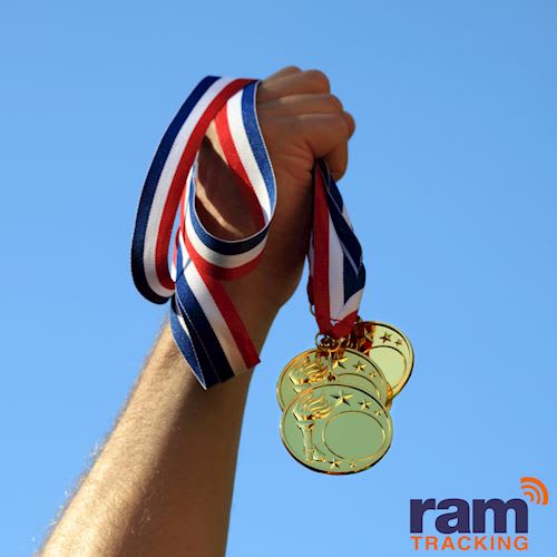 image shows a hand grasping 3 medals 